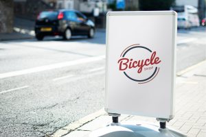 Bicycle shop sign mockup on the street of the city