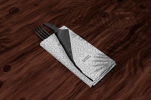 Folded Napkin with Utensils on Table Mockup
