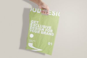 Hand Holding Merchandise Plastic Bag Mockup