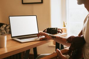 Man with Tattoo Using Laptop Mockup Design