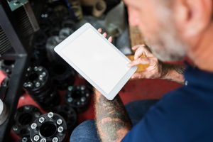 Man with Tattoo Using Tablet Mockup