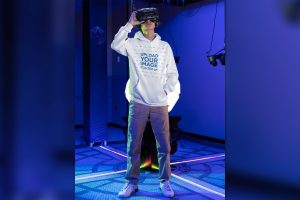 Mockup of a Gamer Wearing a Hoodie at a VR Gaming
