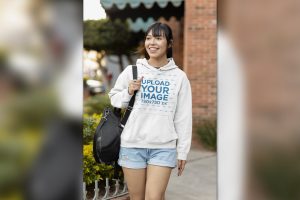 Mockup of a Smiling Woman Wearing a Pullover Hoodi