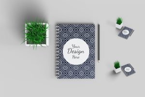 Notebook Mockup with plant and pencil