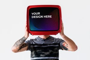 Person with tattoo holding television mockup