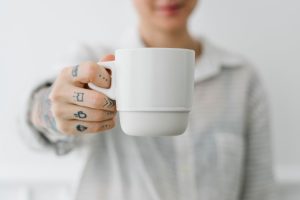 Woman having a cup coffee mockup
